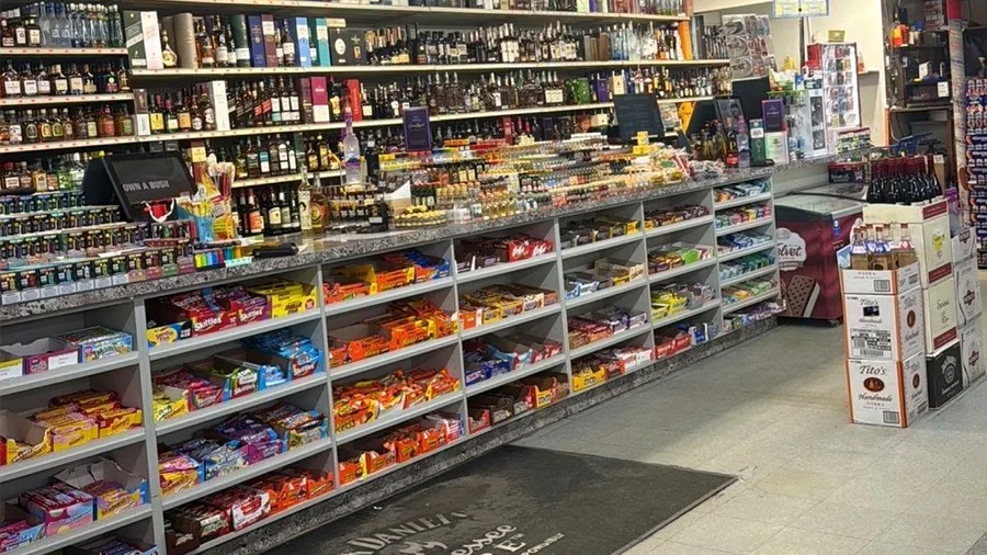 Candy and convenience shelves inside Harrison Liquor & Wine Market