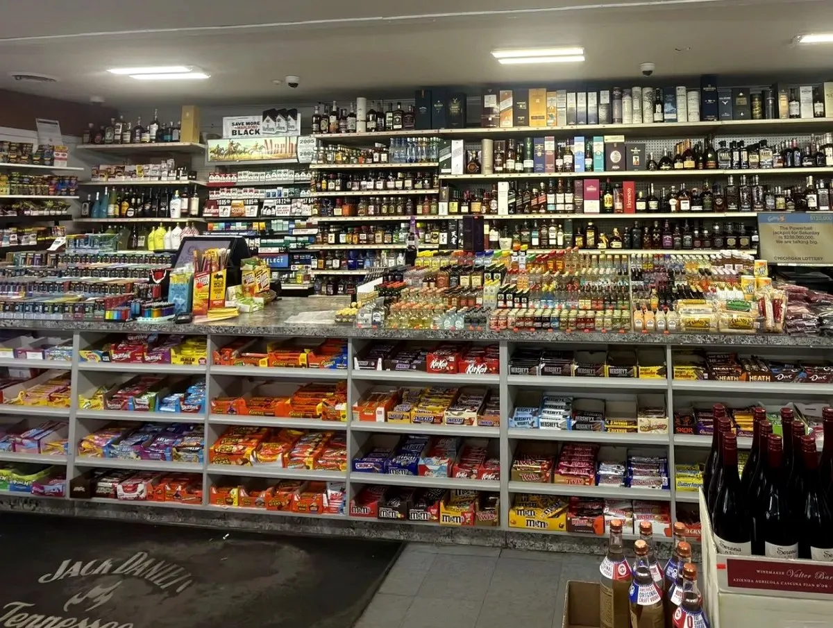 Counter shelves and product wall inside Harrison Liquor & Wine Market