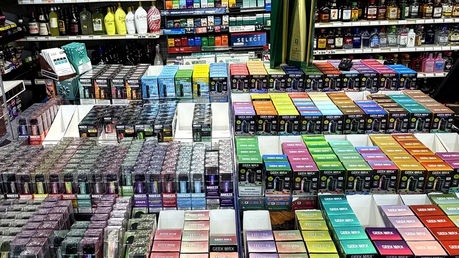 Real vape and adult product counter display inside Harrison Liquor